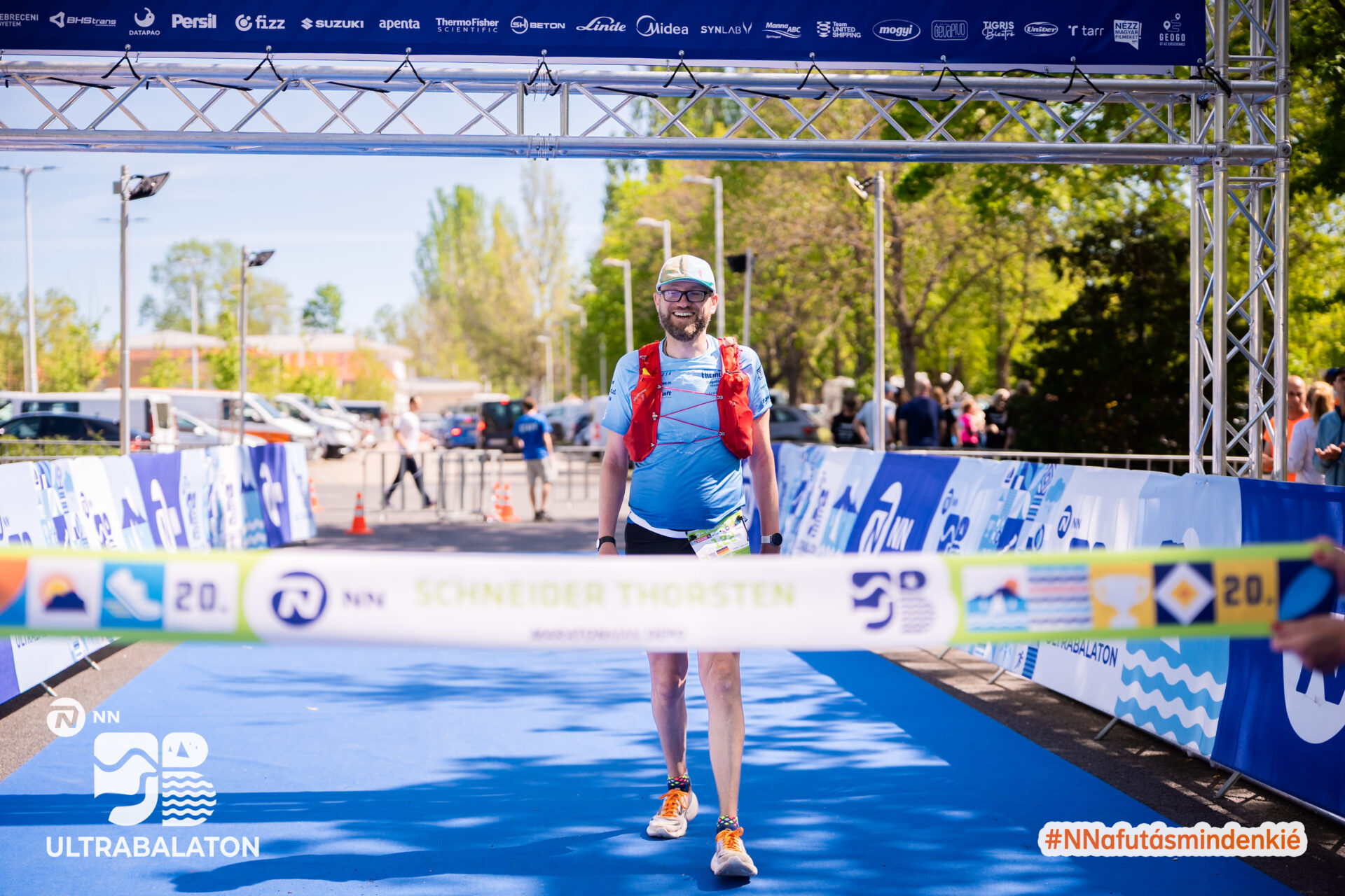Läufer Thorsten Schneider überquert lächelnd die Ziellinie beim NN Ultrabalaton